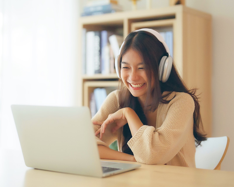 Asian Woman at a laptop for individual therapy in New York