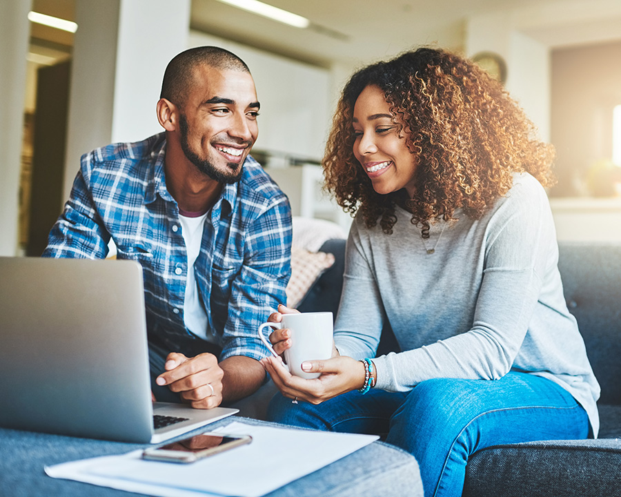 Black couple in front of a laptop ready for online couples therapy in NY