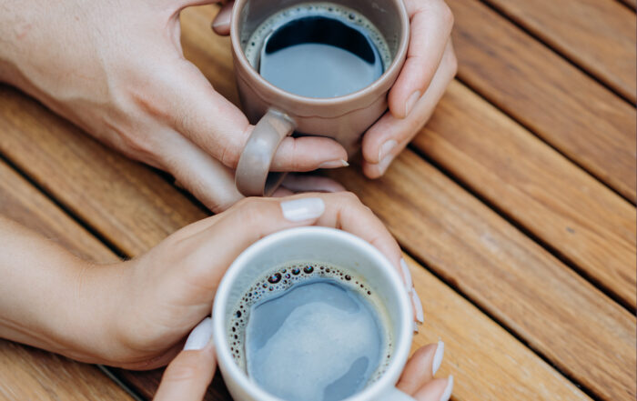 Coffee cups in hands. Who to share with