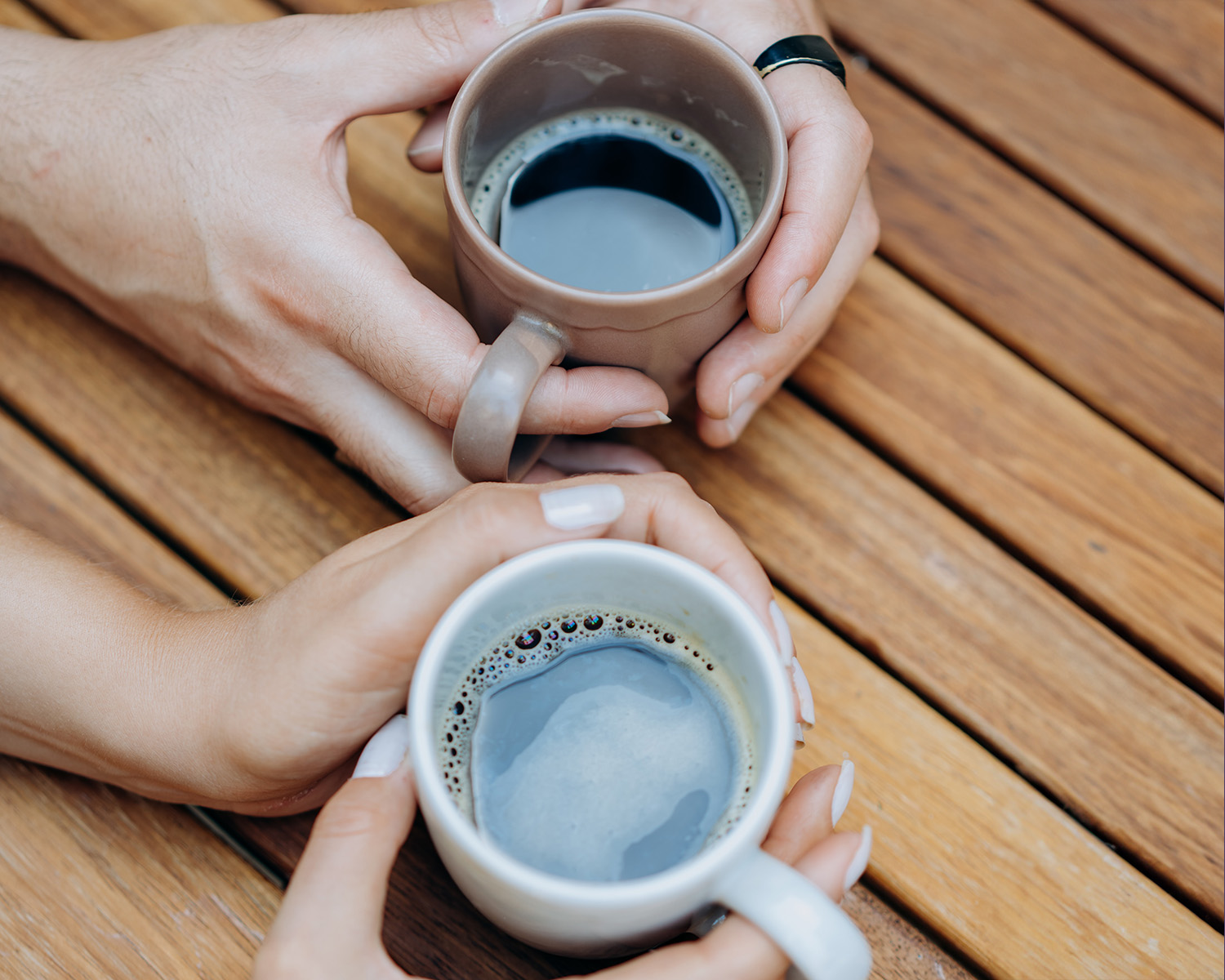 Coffee cups in hands. Who to share with